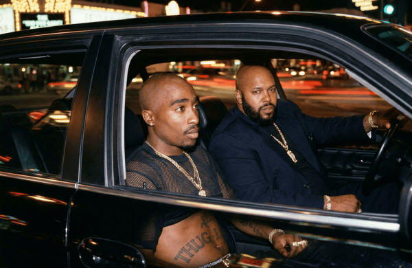 Two men seated in a car on Las Vegas Boulevard at night